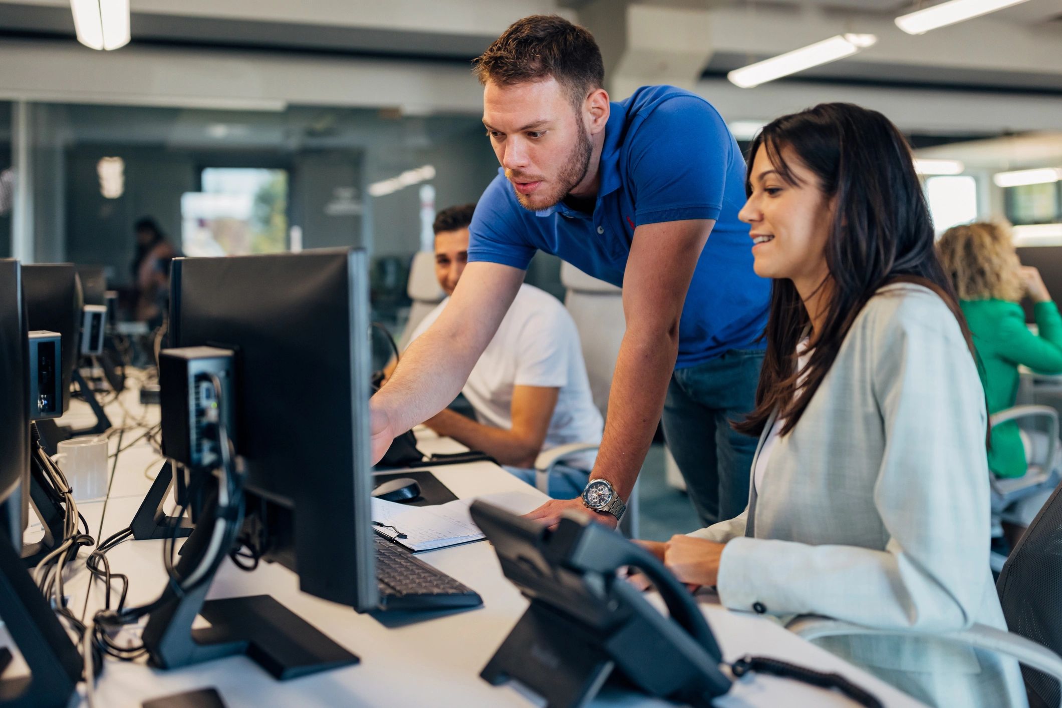 Team leader showing something on a computer to a colleague