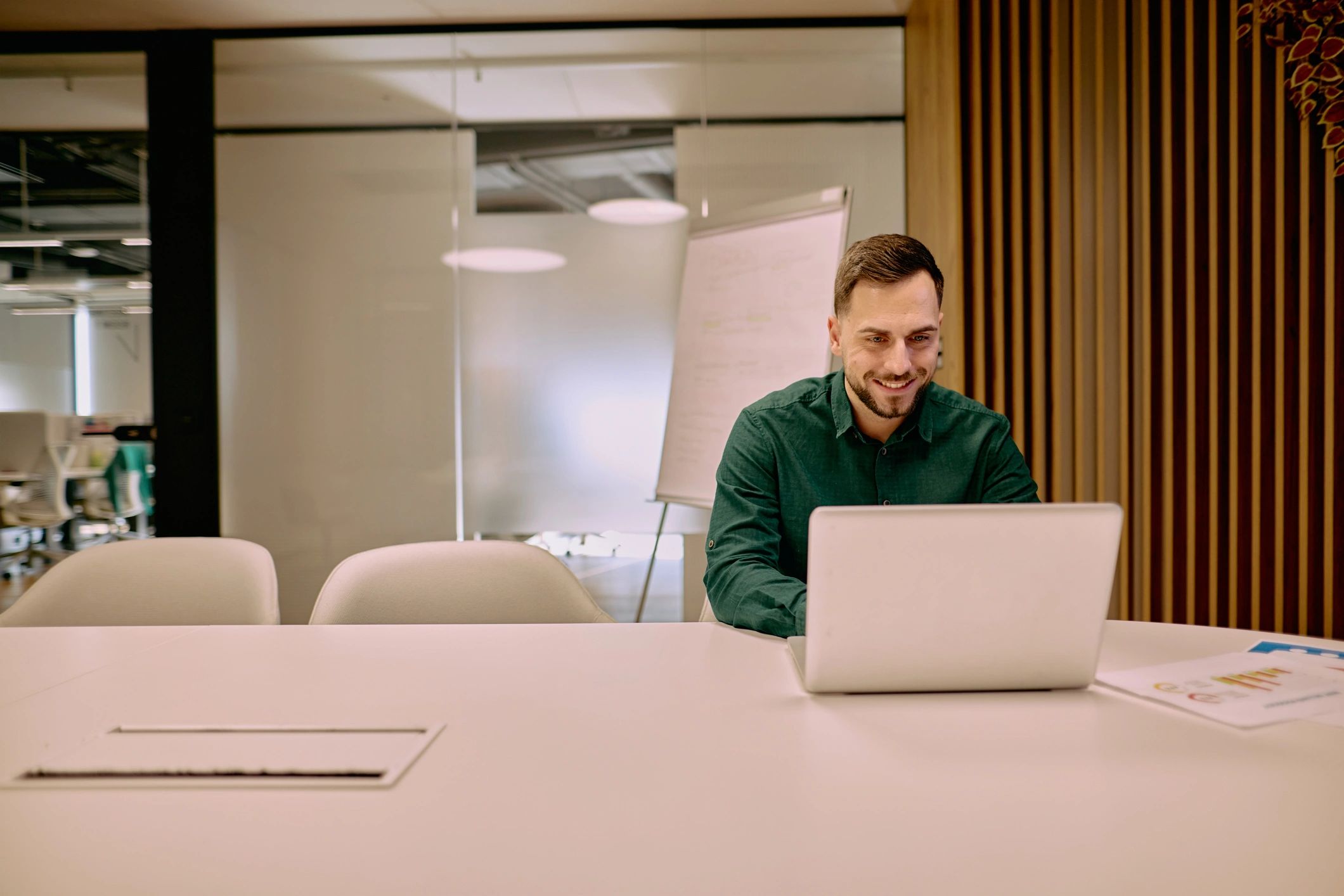 Business professional working on a laptop in a modern office