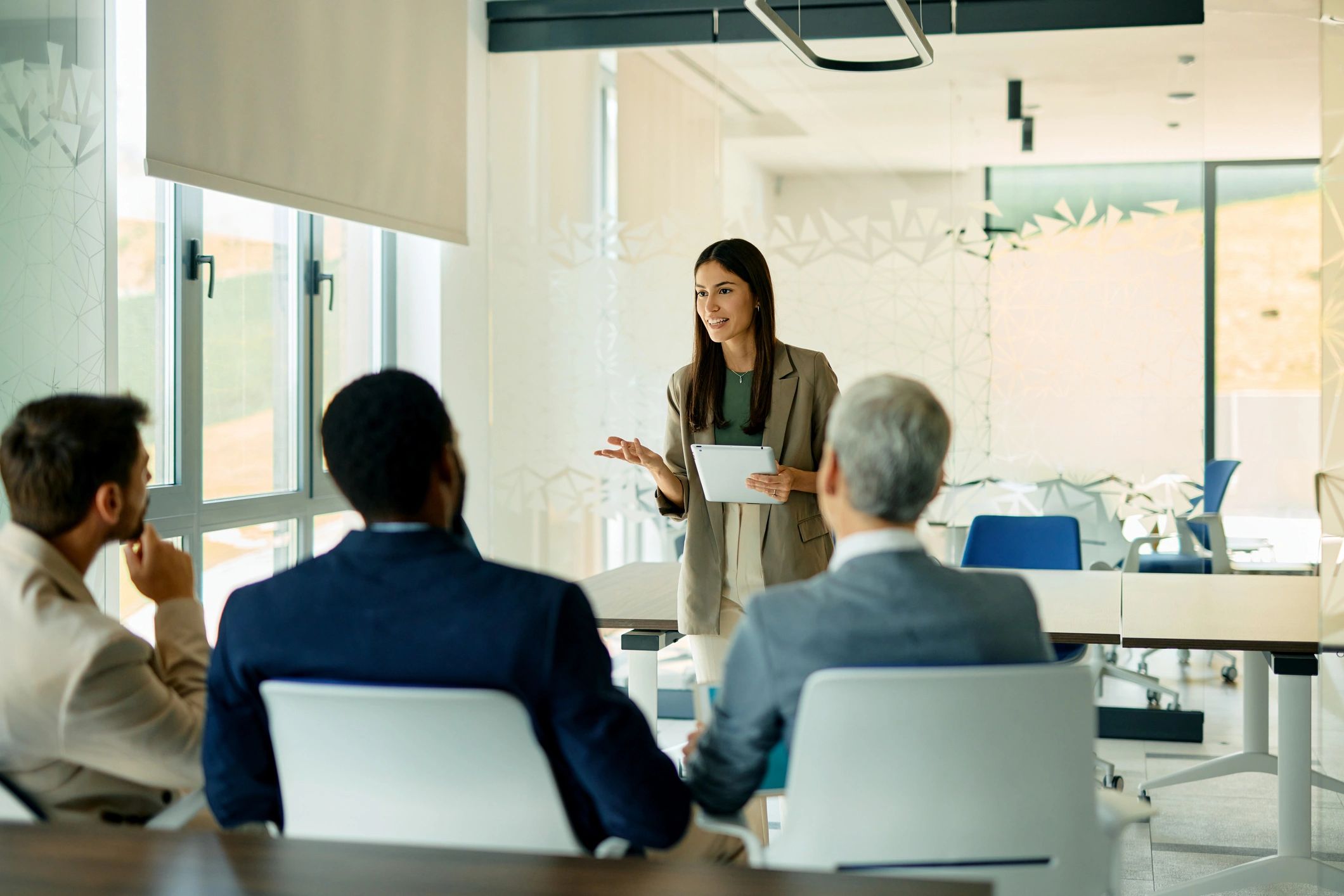Businesswoman leading a meeting with a tablet
