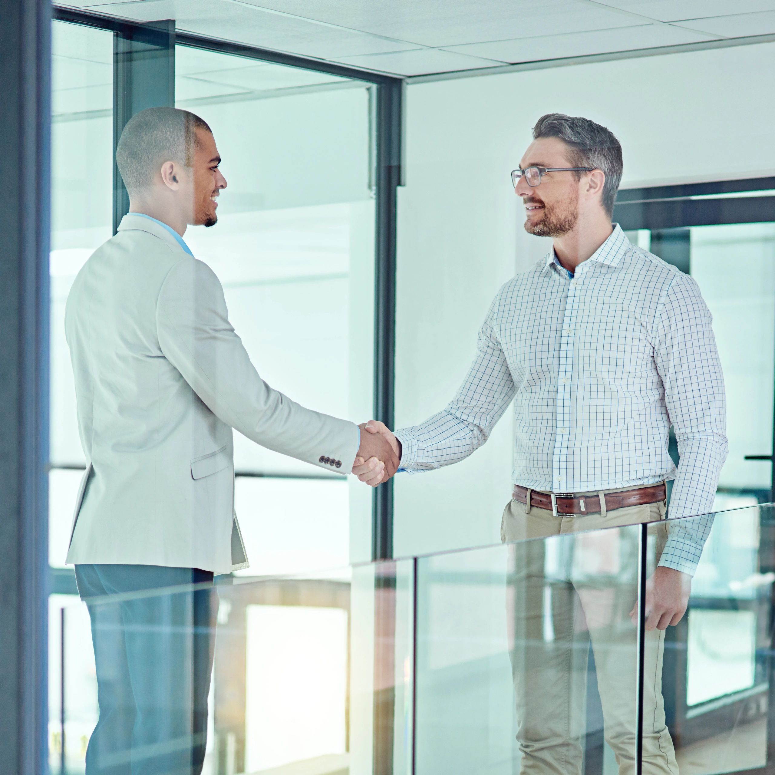 Two professionals shaking hands in an office